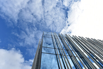 Skyscraper from a low angle view, glass facade against blue sky