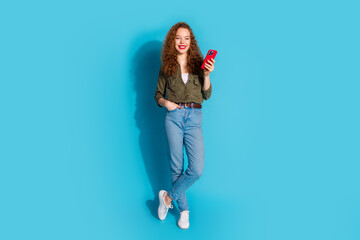 Full size photo of nice young lady hold smart phone wear shirt isolated on teal color background