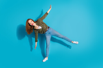 Wall Mural - Full size photo of nice young lady dance empty space wear shirt isolated on teal color background