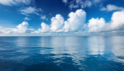 Wall Mural - a serene seascape with calm blue waters and fluffy white clouds reflecting in the gentle waves