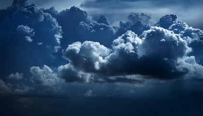 Wall Mural - a dark blue sky with some clouds in it