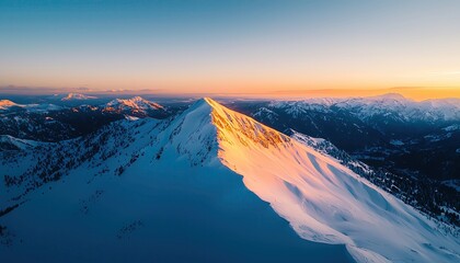 realistic photo of a snowy mountain peak at sunset with golden light on the summit, landscape drone 