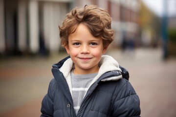 Poster - childhood, fashion and people concept - smiling little boy in winter jacket outdoors