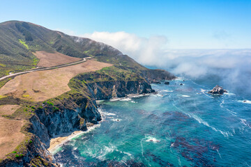 Beautiful landscape of Pacific Ocean coast along Highway 1 and Big Sur, aerial view, sunset, sunrise, fog. Concept, travel, vacation, weekend