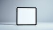 © Роберт Гастон - Tablet with Black Frame and Blank White Screen Positioned Upright Against Soft Gradient Light Gray to White Background