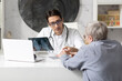 © Vitaliy - Old man visiting young male doctor rheumatologist in modern clinic
