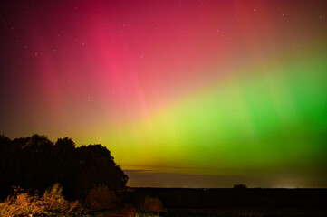 stunning aurora borealis lights up the night sky with vibrant colors, creating a mesmerizing natural