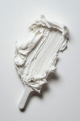 Wall Mural - A spatula with a dollop of whipped cream on a clean white surface