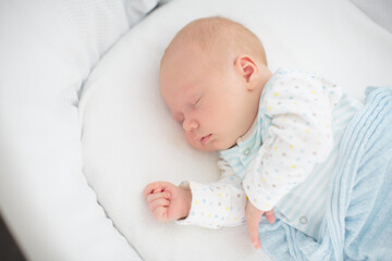Wall Mural - little baby on white bed