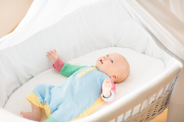 Wall Mural - cute baby boy in a white crib