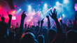 © Curioso.Photography - Crowd of people with raised hands at a concert under colorful lighting, enjoying live music.