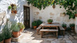 © Dawid - Mediterranean-inspired patio with white stucco walls, stone flooring, and natural decor in an airy outdoor space