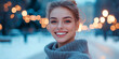 © Iryna - Smiling woman in a cozy sweater with blurred winter city lights in the background