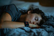 © Vera - Individual peacefully sleeping while a smartwatch with sleep tracking and heart rate monitoring capabilities records essential information.