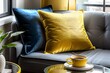 © Vectplus - closeup of golden and blue pillow on sofa with cup of coffee on the table