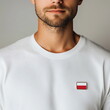 © Milan - Man wearing a Poland flag pin on white t-shirt. Polish patriotism and national pride concept. Poland independence day. November 11