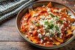 © Sayfar - Chilaquiles drenched in red sauce and sprinkled with queso fresco