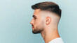 © Marketplace - Profile view of a young man with a modern fade haircut against a light blue background, showcasing trendy hairstyle and confident expression.