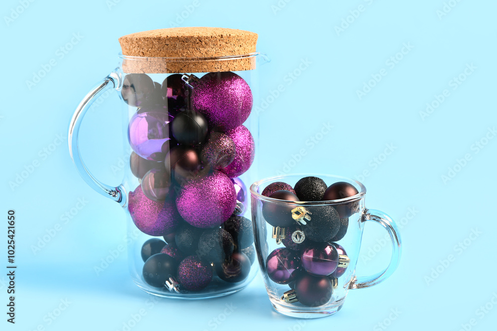 Glass pitcher and cup with beautiful Christmas decorations on color background