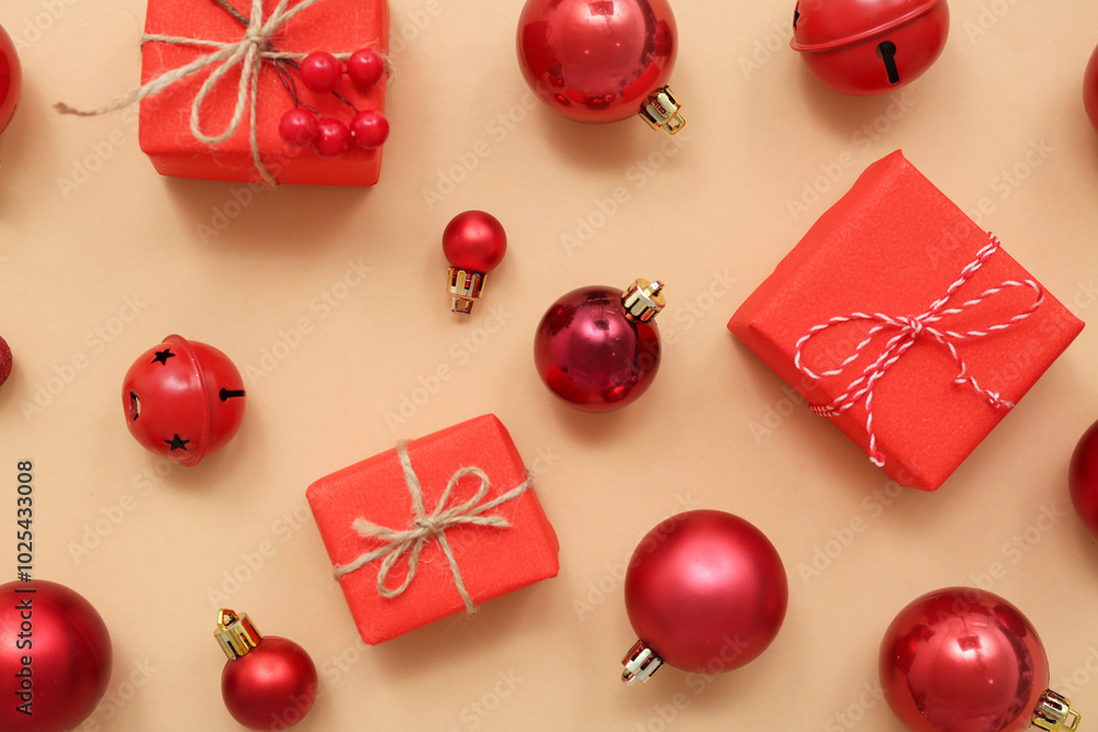 Composition with red Christmas balls and gift boxes on beige background