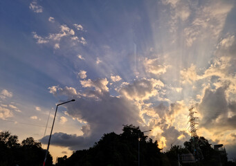 Wall Mural - 
It's a sunset sky with sunlight shining through the clouds.