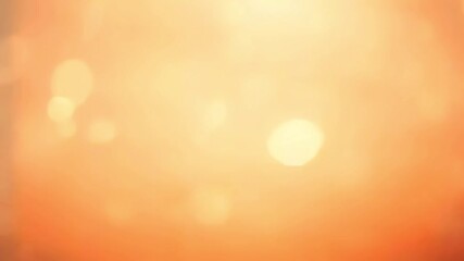 Wall Mural - soft golden bokeh lights on a warm orange gradient background. abstract blurred effect for festive o