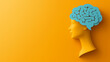 © keystoker - The illustration displays a bright yellow silhouette of a human head with a blue brain, symbolizing psychological health and the complexity of thoughts and emotions, copy space