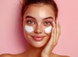 © munja02 - Beautiful young woman with radiant skin applying face cream on a pink background, close-up portrait of a beautiful girl model using facial cream