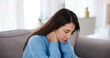 © Nina2024/peopleimages.com - Woman, neck pain and stress on sofa in home with muscle tension, injury and burnout. Person, body strain and uncomfortable on couch with inflammation, fibromyalgia and joint pressure in living room