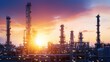 © NATTAWUT - Oil refinery at sunset with a glowing sky and shining metal towers