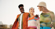 © Flashizzle/peopleimages.com - City, laughing and friends with walking for fashion, streetwear and bonding together with gen z style. Diversity, man and women with hug for summer clothes, sunglasses and happy with reunion outdoor