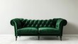 © Imsuniyah - A Green Velvet Chesterfield Sofa Against a White Wall