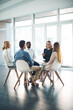 © Koegelenberg Coop/peopleimages.com - Mentor, team building and talking with business people in office for meeting, training or planning. Support, collaboration and development with employees in circle for communication and mission