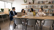 © fizkes - Diverse team of adult students talking at large table in library with bookshelves in background, using laptops. Business team brainstorming on startup project, talking in meeting room. Banner shot