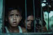 © cff999 - a boy and a dog look out from behind bars