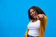 © Sanc/peopleimages.com - Portrait, excited and woman pointing in studio for vote, decision and winner with success opportunity. African, girl and hands gesture with offer of promotion, announcement and yes on blue background