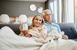© CamPen2000/peopleimages.com - Blanket, coffee and thinking with couple on sofa in living room of home together for bonding, break or romance. Cozy, cuddle or hug with mature man and woman in apartment for idea, love or romance