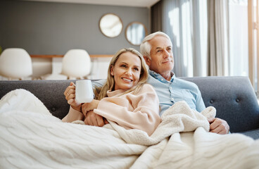 blanket, coffee and thinking with couple on sofa in living room of home together for bonding, break 