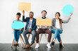 © Koegelenberg Coop/peopleimages.com - Portrait, smile and speech bubble with business people in studio for advertising or marketing. Collaboration, mockup space or voice with happy man and woman employee group in office for communication