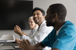 © fizkes - Motivated young man medical specialist professional oncologist cardiologist share funny idea bright insight at meeting room in clinic. Diverse medic group listen to happy doctor having fun on briefing