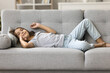 © fizkes - So soft and cozy. Adorable little child girl relax lying on back on large comfortable couch at living room feel carefree lazy serene peace of mind enjoy good day spend leisure time at home on weekend