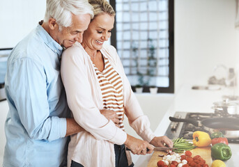 Poster - Mature couple, cooking and hug in kitchen for bonding, relationship and support together with romance. Happy people, meal prep and embrace in apartment for anniversary, marriage and food with partner