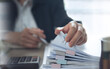 © tippapatt - Document management. Businesswoman working with stack of paper files for searching and checking corporate files, document achieves on folders paper on office table, closeup