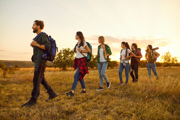 Group of people together hiking in nature, enjoying an adventure and excursion. This team is on a trip, making the most of vacation or weekend through a thrilling hike in the great outdoors.