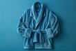 © Your Choice - Soft blue bathrobe hanging against a teal background in a cozy interior setting