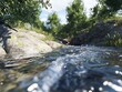 © สมเจตน์ หนูแก้ว - Flowing water stream amidst lush greenery and rocks