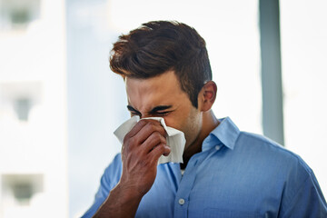 Canvas Print - Blowing, nose and sick business man in office with flu virus, allergies and health problem at workplace. Professional, ill employee and sneeze in tissue for medical disease, sinusitis and hayfever