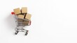 © Bonsales - Shopping cart filled with cardboard boxes on white background, symbolizing online shopping and delivery services.