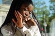 © AstrorickyPhotograpy - Young woman of color sits in a cafeteria and smileys at the camera