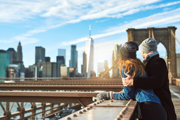 Couple, hug and view in city on vacation, honeymoon adventure and sightseeing on holiday. People, bridge and travel to New York with back on weekend, outdoor together and embrace for security on date